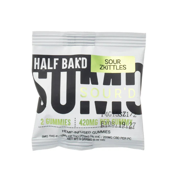 A silver packet labeled Half Bak’d Sumo Sour’d Gummies | 420mg (2ct) by Half Bak'd contains 2 hemp-infused gummies. The packaging features bold black and blue text on a white background.