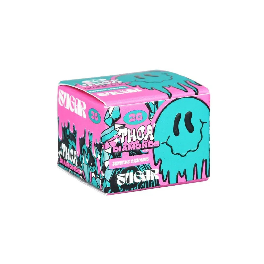 A small, colorful box labeled Trippy Sugar THCa Diamonds 2G | 5-Pack by Trippy Sugar features a turquoise cartoon face with pink, blue, and black accents. "Sugar" highlights its premium solventless THCA Crystals.
