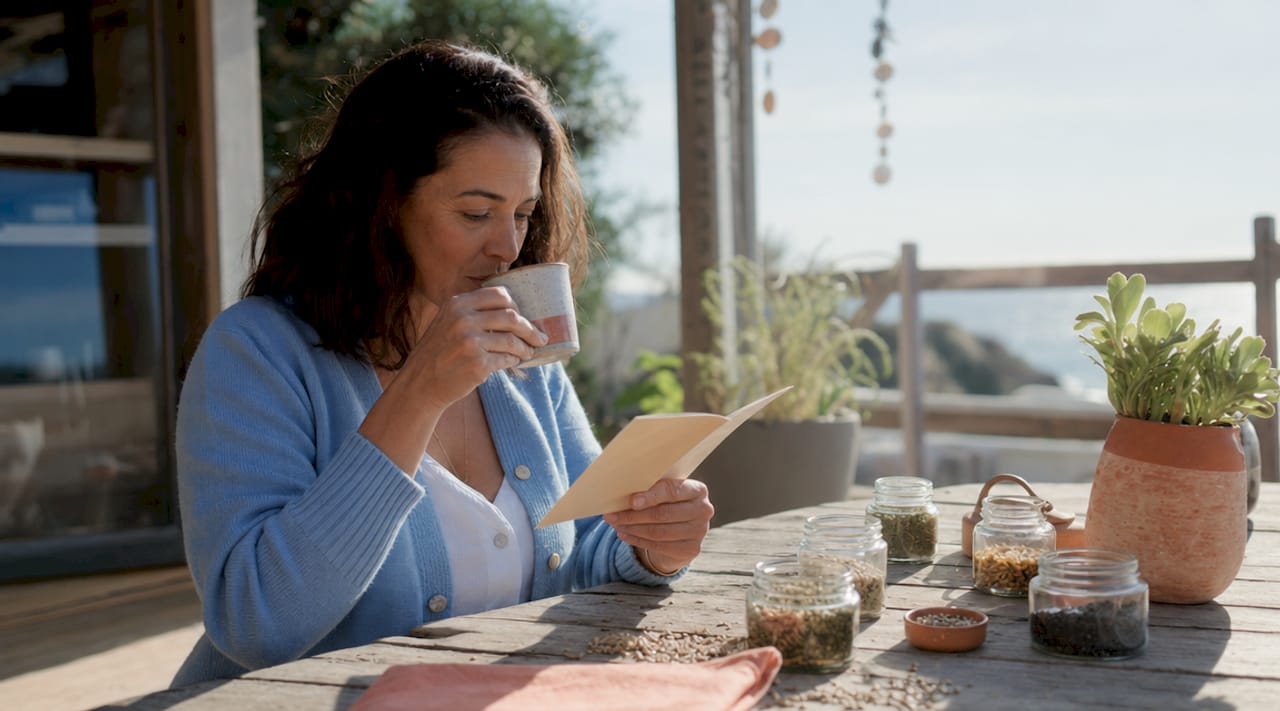 Woman reviewing hemp focus supplements at kitchen table