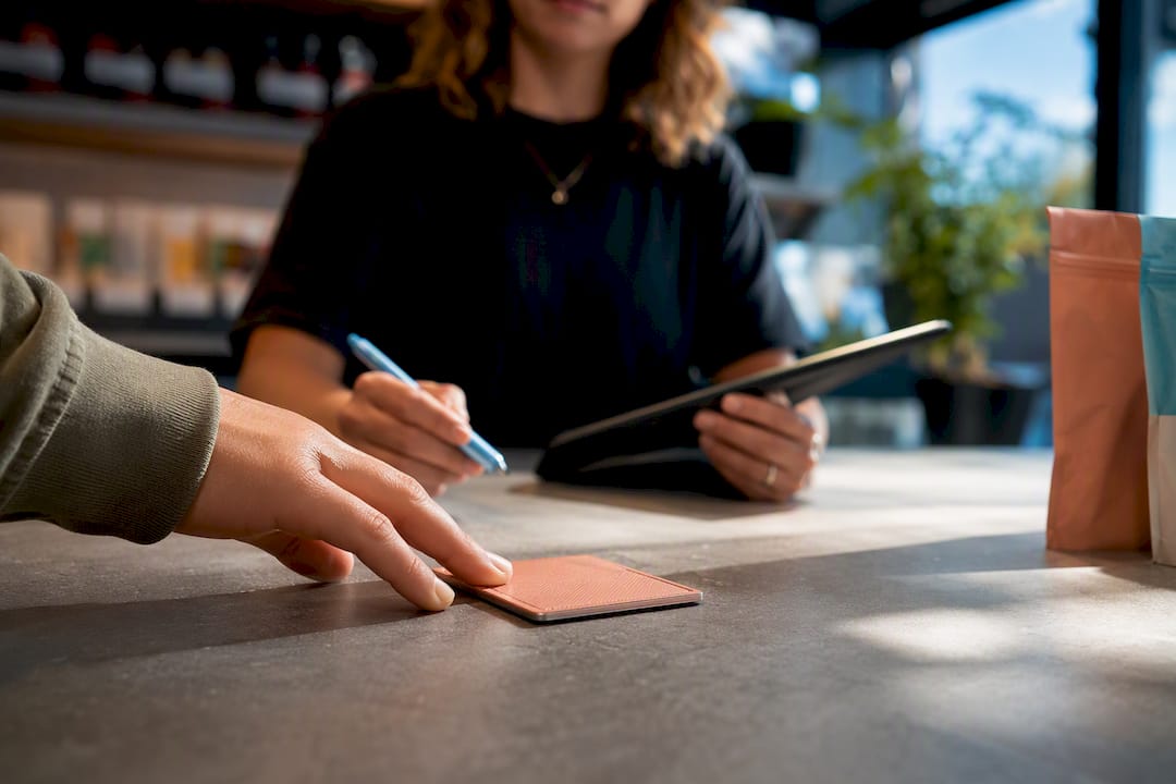 Clerk checking shopper identification at checkout